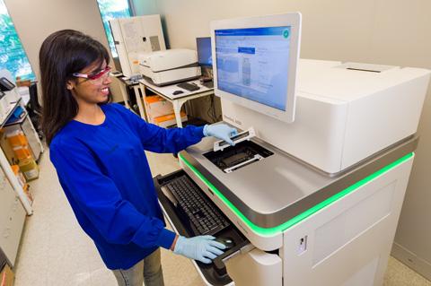 Photo of Sequencing Facility employee working with the NovaSeq 6000