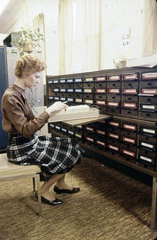 A woman at a card catalog