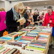 A woman checks out with her new books at the 2017 Book and Media Swap.