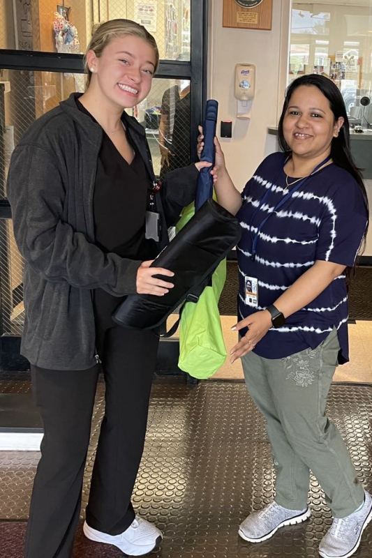 Raffle winner Swati Priya (right) poses with Taylor Johnson. (Photo by authors.)