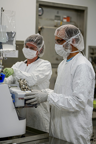 BDP staff preparing to sterilely weld (fuse) a bag of cell growth media to the Prodigy system to cultivate the CAR T cells. (Photo provided by BDP)