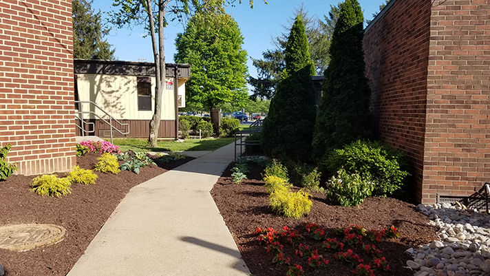 The landscaping creates an inviting path for those passing toward the center of campus.