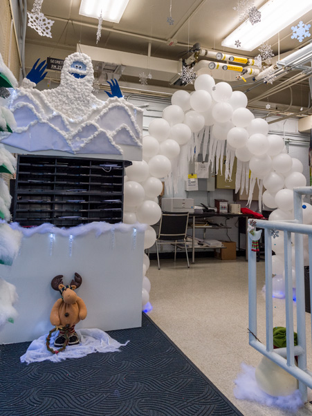 The abominable snowman (upper left), mascot of Building 539-1CB’s theme, watches over the decorations. (Photo by Samuel Lopez)