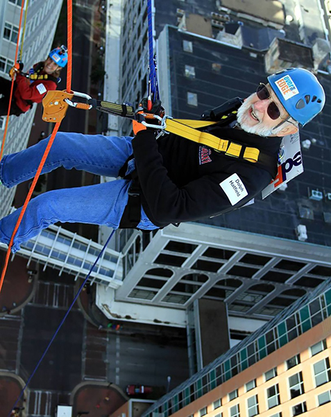Hatfield and daughter Sandy (background, left) on their Des Moines skyscraper rappel. (Image contributed by Dolph Hatfield.)