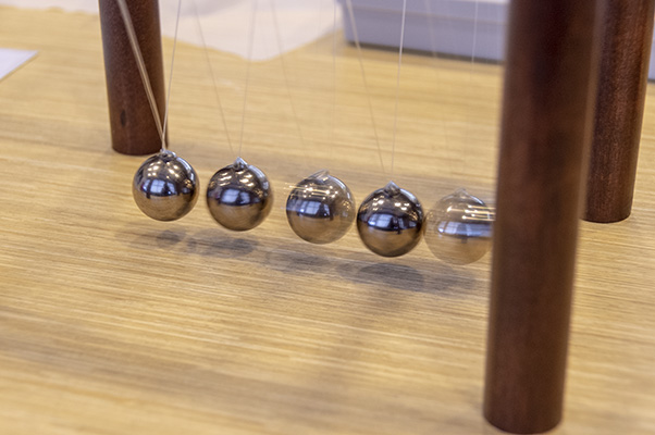 A Newton’s cradle demonstrates the third law of motion.