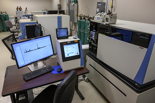 The Orbitrap Fusion (right, foreground) and its two predecessors: the Orbitrap Elite (center-left, midground) and the Orbi XL (center-left, background).