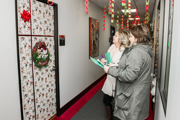 Judges Lisa Hill (background) and Lorie Maith-Sanders, from the Army Garrison, Army Community Service, evaluate decorations. 