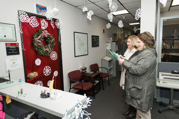 Judges Lisa Hill (background) and Lorie Maith-Sanders, from the Army Garrison, Army Community Service, evaluate decorations.