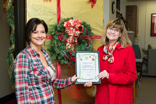 Raejean Hermansen (left), and Linda Brubaker, were among the award winners in Building 428, which earned first place, Building category, for “A Traditional Christmas.”
