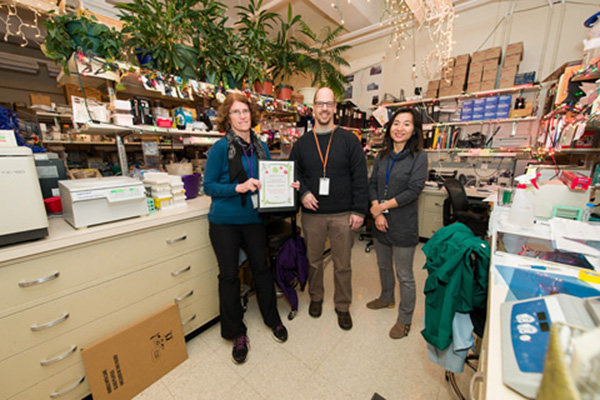 Second place, Group category, was awarded to, from left, Della Reynolds, Michael Sanford, and Rachel Bae, for “Christmas in the Lab.”