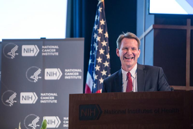 NCI Director Dr. Norman E. Sharpless takes the podium to say a few words. 
