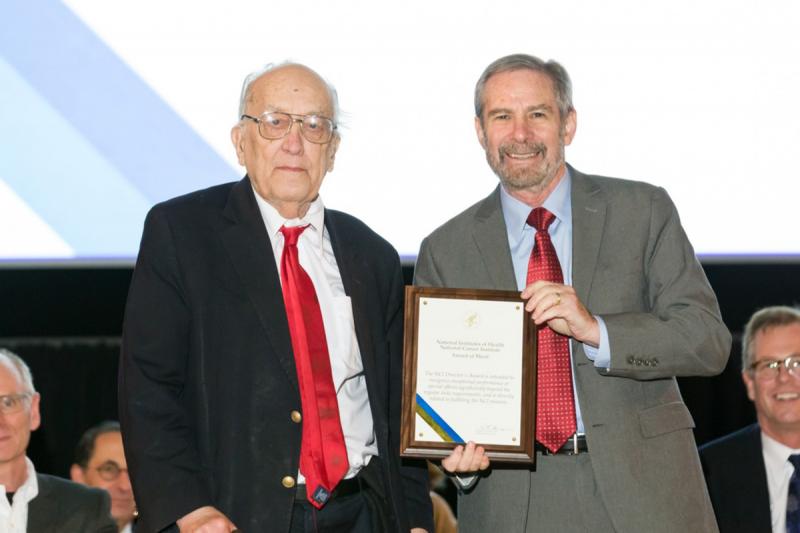 Dr. Glenn Merlino presents Dr. Thomas A. Waldmann with a special Length of Service Award. 