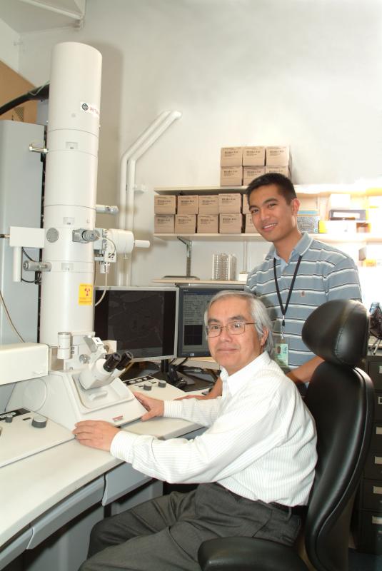 Kunio Nagashima (seated) and then-assistant M. Jason de la Cruz demonstrate the first all-digital TEM acquired by the EML in 2007, when it was located in Building 538. (Photo from the SPGM archives)