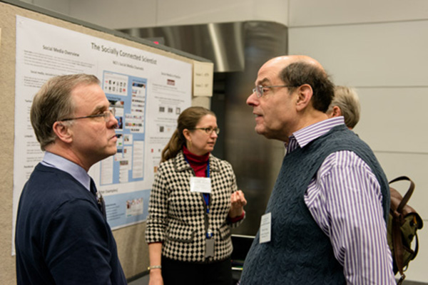 Mark Story, NCI Office of Communications and Public Liaison (left), in discussion with Howard Young, Ph.D., deputy chief, Laboratory of Experimental Immunology, and principal investigator and head, Cellular and Molecular Immunology, Center for Cancer Research. 