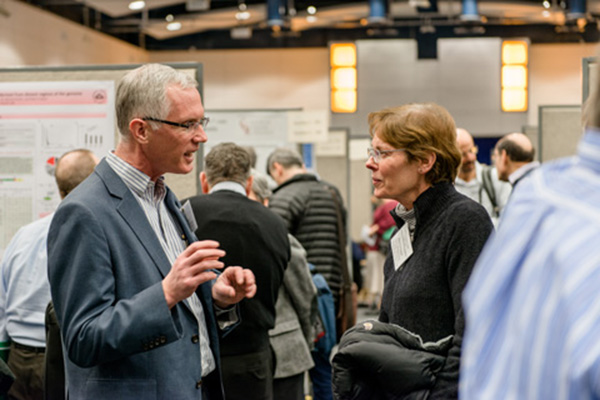 David Heimbrook, Ph.D., laboratory director, Frederick National Laboratory for Cancer Research, and president, Leidos Biomedical Research, speaks with Mary Carrington, Ph.D., senior investigator, Laboratory of Experimental Immunology, during one of the poster sessions at the retreat. 