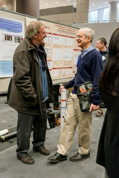 Stuart Le Grice, Ph.D., senior investigator, Basic Research Laboratory (left), chats with Robert Yarchoan, M.D., chief, HIV and AIDS Malignancy Branch, at one of the poster sessions.