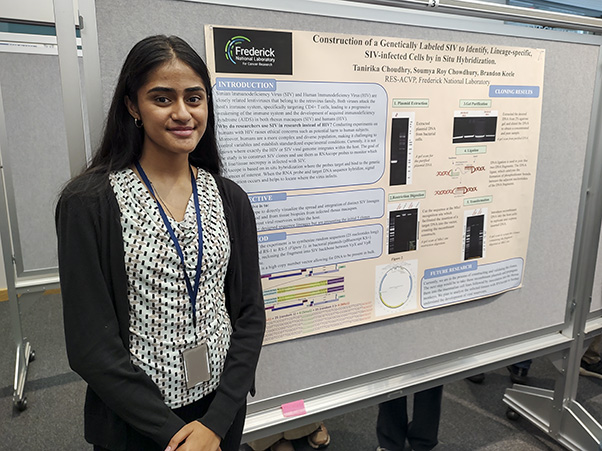 Tanirika Choudhry poses with her poster, the culmination of her summer work on genetically labeling viruses.