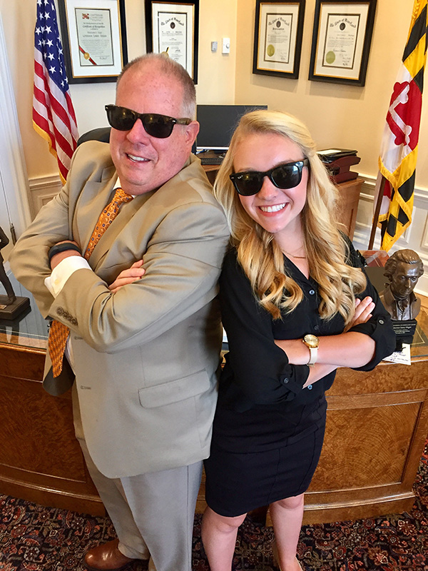 Julianne Heberlein and Governor Larry Hogan pose while wearing their matching sunglasses.