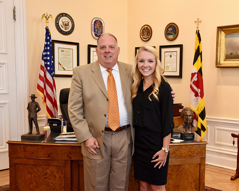 Julianne Heberlein stands with Governor Larry Hogan on the last day of her internship in the governor’s personal office in the Maryland State House.