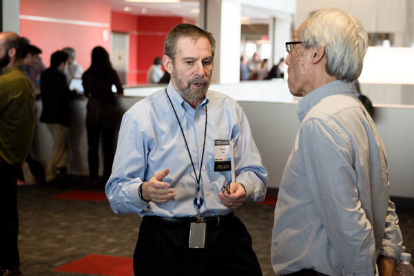 NCI Assistant Director Doug Lowy, M.D., (left) conversing with University of North Carolina’s Channing Der, Ph.D.