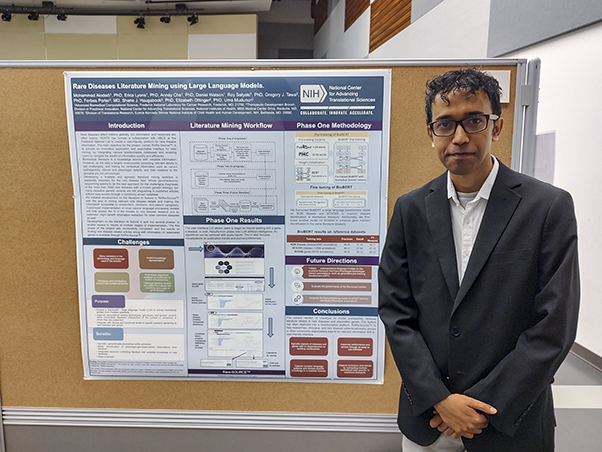 Satyaki Roy, Ph.D., poses with his team’s poster at the poster display.
