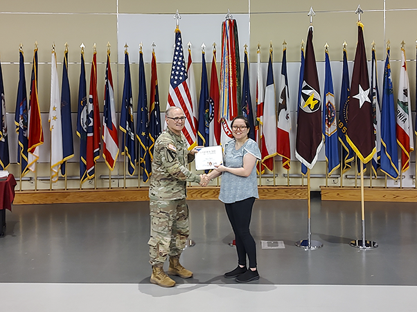 Susan Egbert (right) receives her award from Brig. Gen. Anthony McQueen, commanding general of the U.S. Army Medical Research and Development Command and Fort Detrick, at the awards ceremony.