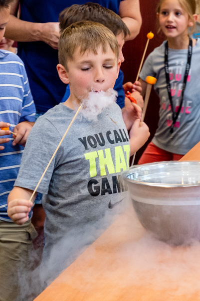 As usual, “Fire and Ice” ended with a hands-on finale: a chance for children to “breathe smoke” like a dragon by eating a cheeseball flash-frozen in liquid nitrogen.
