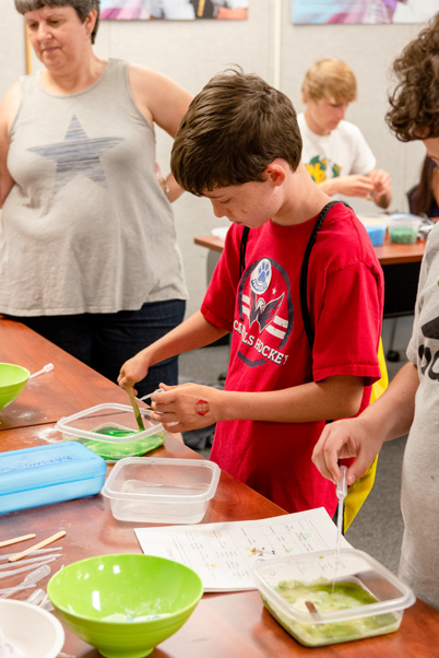 In addition to making slime (shown above), children visiting the Science Room could learn about osmosis, balance, and other scientific principles.