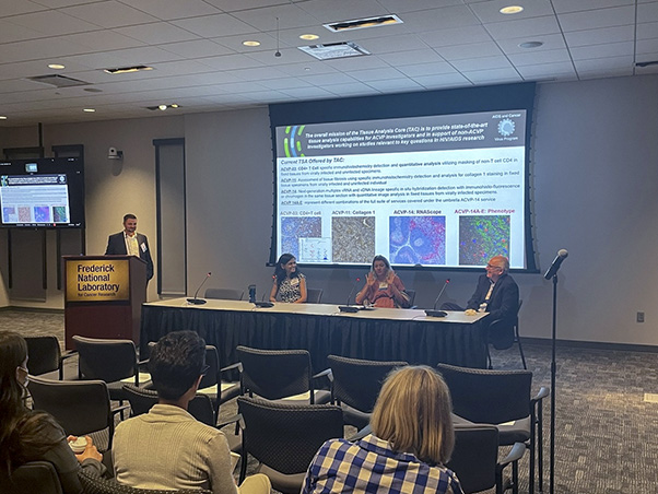Vladimir Popov, Ph.D., FNL’s chief innovation officer, (left) moderates a panel of FNL scientists at the showcase.