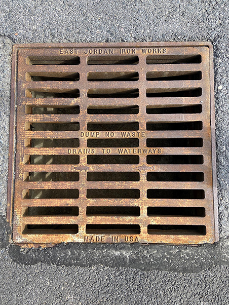 A drain on the NCI at Frederick campus reminds passersby, “Dump no waste; drains to waterways.” (Photo by Kylee Stenersen, EHS)