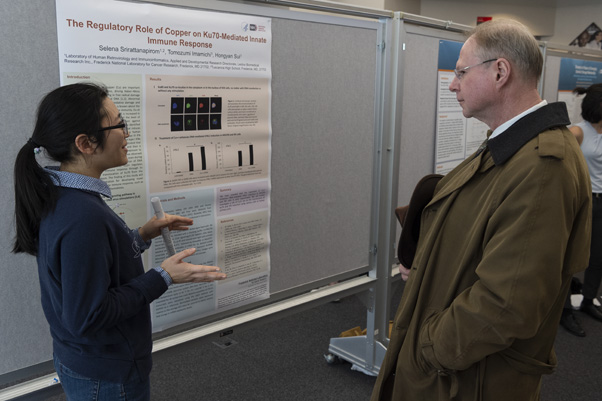 Selena Srirattanapirom speaks with Walter Hubert, Ph.D., about her project, a study of copper’s role in the immune system’s response to invaders.