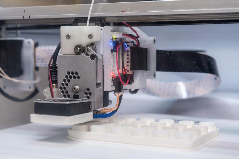 A 3D printer creating materials for the lab.