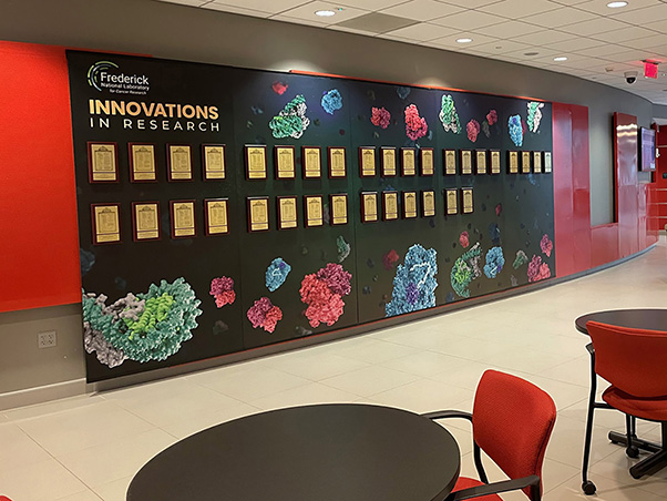 The new “Innovations in Research” wall and all the patents can be seen in atrium at the FNL’s ATRF. (Photo credit: Paul Horning)