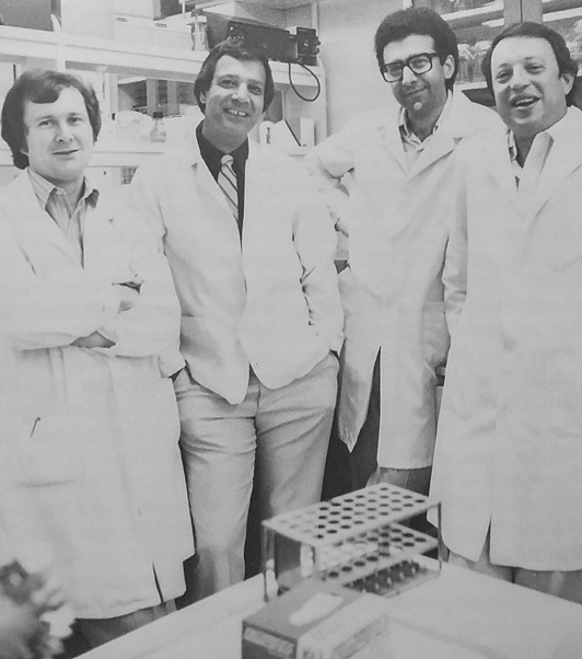 Senior staff in the Cancer Metastasis and Treatment Laboratory, Dr. Isaiah “Josh” Fidler’s program that became independent from the Basic Research Program in 1980. From left: Ian Hart, Michael Hanna, Nabil Hanna, and Isaiah Fidler. Photo likely taken in 1981. (1981 annual report)