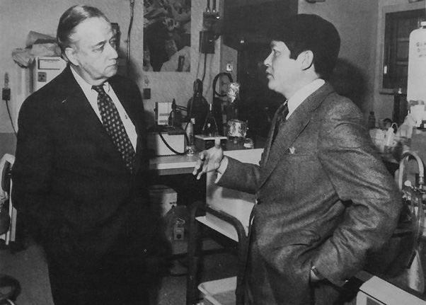 The program received visits from domestic dignitaries as well. Here, Basic Research Program scientist Dr. Robert Yuan (right) speaks with Senator Charles McC. Mathias during the latter’s tour of FCRC. (FYI News)