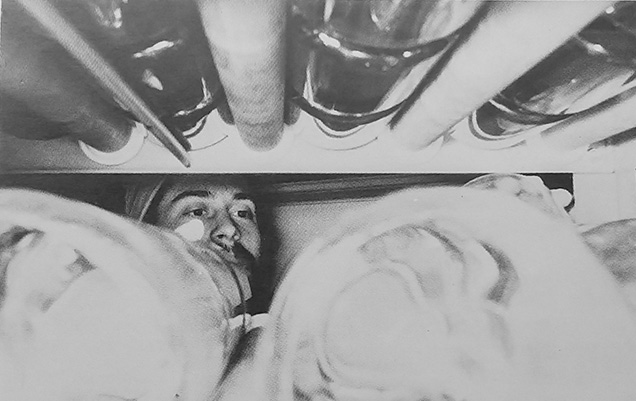 A Cancer Biology Program employee handles a rack of containers, likely in 1980. (1980 annual report)