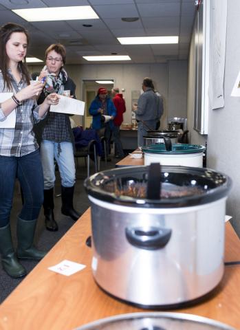 People tasting chili.