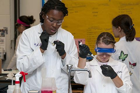 Photo of two high school students performing an experiment at the Career and Technology Center