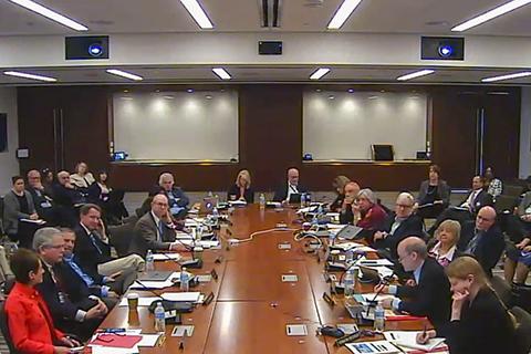 Photo of FNLAC members gathered around the meeting table