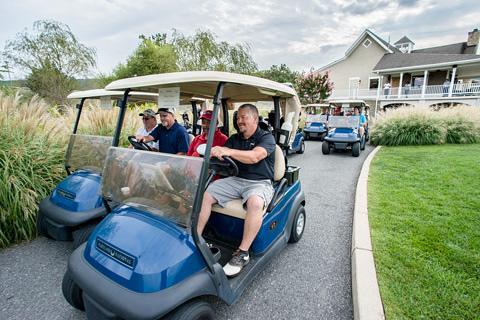 Golfers in golf carts.