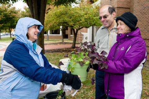 Howard Young and Dolores Winterstein receiving a plant from a participant