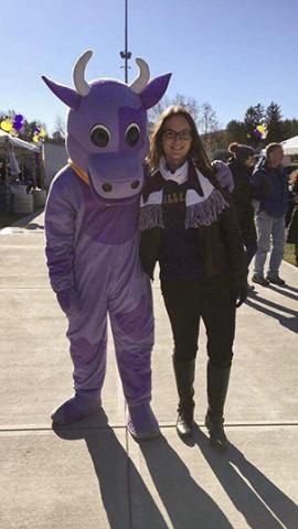 Photo of Maddie Hurwitz with Williams College's mascot, Ephalia, a large purple cow