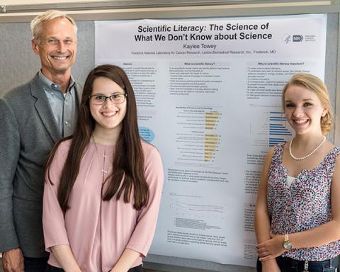 Kaylee Towey (center) with Frank Blanchard (left) and fellow WHK intern Julianne Heberlein (right) presenting a poster at Student Poster Day. 