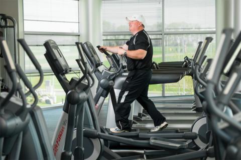 Shawn Kelly exercises on an elliptical machine at the ATRF