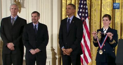 Schiller, Lowy, President Obama, and military aide holding medal at ceremony.