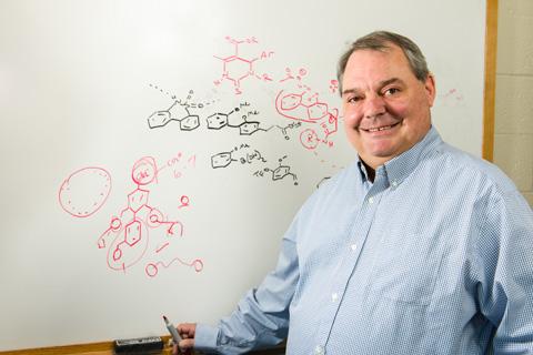 Man standing by a write board