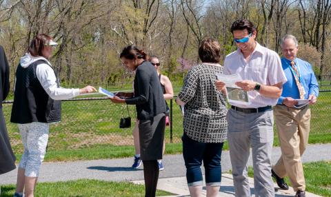 Participants receive their Puzzler handouts and prepare for the march. 