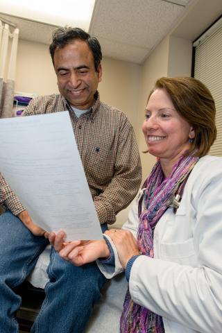 Doctor and patient review a report together.