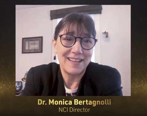 Dr. Monica Bertagnolli, director of the National Cancer Institute, smiling and wearing glasses, addresses the audience via webcam.