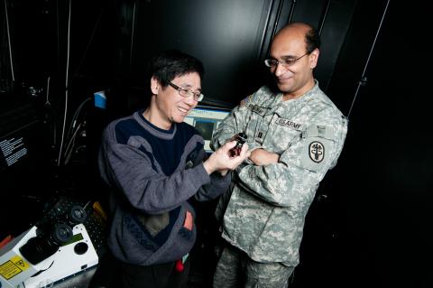 Two men viewing an instrument.